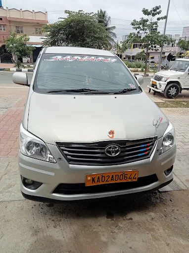 Janani Tours and Travels Toyota Innova Crysta parked in Shivamogga